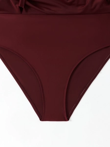 Macro detail of high-elastic burgundy swimsuit fabric with reinforced stitching