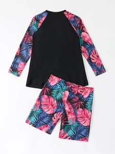 Detail of two-piece long sleeve rash guard with vibrant tropical leaf print pattern