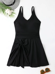 Detail of black one-piece plus size swim dress with waist cut and side twist knot detail