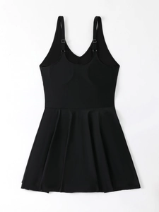 Flat lay of a black plus size swim dress with pleated hem and adjustable straps
