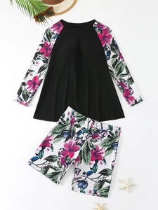 Detailed flat lay of long sleeve plus size tankini set with tropical floral print sleeves