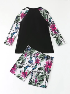 Detailed flat lay of long sleeve floral rash guard set with black torso and boy shorts