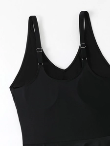 Close-up of adjustable thin straps and silver buckle on black plus size swimwear