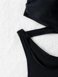 Detailed view of black swimsuit featuring cutout design and high-quality flatlock stitching