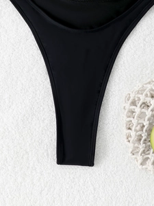 Close-up of smooth black swimsuit fabric with premium stitching on white towel