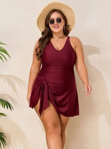 Plus size one-piece wine red swimdress with deep V-neck and decorative side bow tie