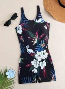 Detailed flat lay of black tropical floral swimsuit with wide straps and boyshorts cut