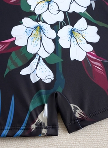 Detailed view of durable double-needle stitching on floral printed tropical swimwear fabric