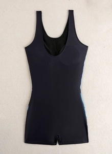 Detail view of black one piece swimsuit with boyshort cut and wide straps on textured fabric