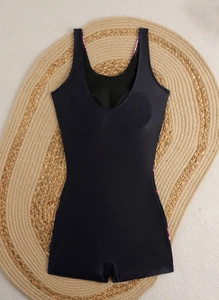Detail view of black one-piece swimsuit featuring built-in pads and a deep U-neckline