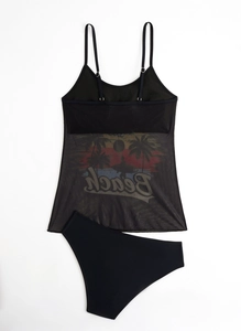 Detail of black bikini set featuring mesh tankini top with tropical beach print