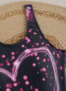 Detail of neon pink heart print on black athletic one-piece swimsuit fabric texture