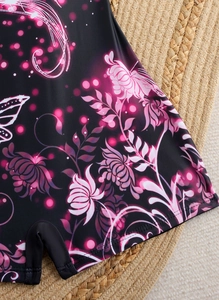 Detail of floral print on black swimwear fabric featuring pink blossoms and clean stitching