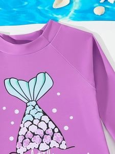 Detail van een paars meisjeszwempak met lange mouwen en een kleurrijke zeemeerminprint