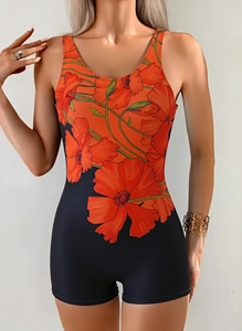 Detail view of one-piece swimsuit featuring orange floral prints and boyleg shorts