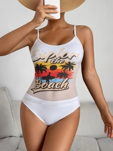 Detail of white swimsuit featuring Explore the Beach sunset print and thin straps