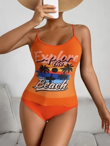 Detail of orange two-piece bikini with tropical sunset graphic and beach lettering