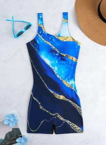 Flat lay of blue marble print one-piece swimsuit with boyshorts and beach accessories