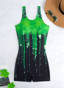Flat lay of green shamrock gradient one-piece swimsuit with sunglasses and straw hat