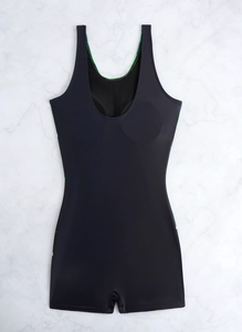 Flat lay of black one-piece swimsuit with square legs and wide straps on marble surface