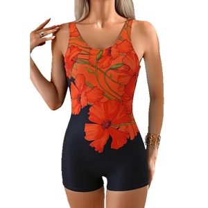 Women's athletic one-piece swimsuit featuring orange floral print and black boyleg shorts