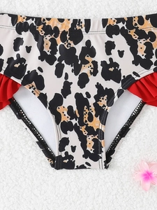 Detail of leopard print bikini bottom with vibrant red ruffle trim for girls