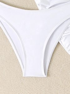 Close-up of white high-cut bikini bottoms with professional flat-seam stitching detail