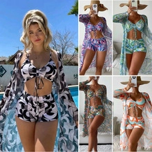 Three-piece bikini set with high-waist shorts and matching sheer cardigan in wave patterns