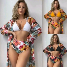 Detailed view of women's three-piece swimwear with high-waist bikini and floral cover-up