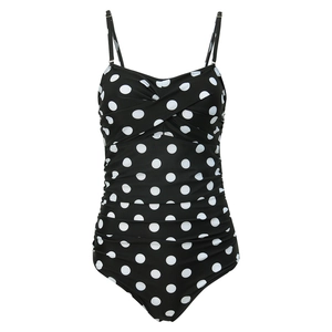 Detail of ruched tummy control side folds on a black polka dot one-piece swimsuit