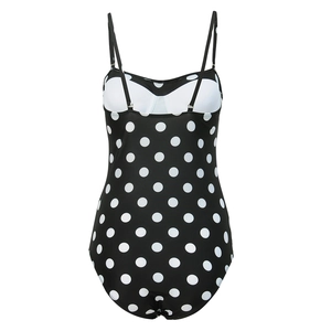 Detail view of black polka dot swimsuit featuring adjustable straps and white chest padding
