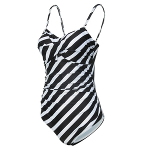 Detailed view of black and white striped one-piece swimsuit with ruched slimming texture