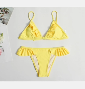 Detail view of bright lemon yellow bikini set featuring sweet ruffled edges and triangle cups