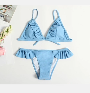 Flat lay of light blue two-piece ruffled bikini set with adjustable straps and frill edges