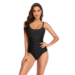 Detail view of the elegant ruched texture and slim shoulder straps on this black swimsuit