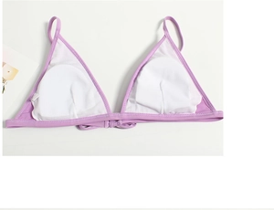 Detailed interior of purple triangle bikini top showing white removable chest pads and tag