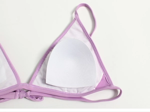 Detail of light purple bikini top featuring breathable mesh lining and removable cup pad