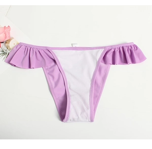 Detail of light purple bikini bottom with white patchwork and ruffled waist accents