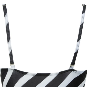 Detail of adjustable thin straps with gold metal buckles on black and white striped swimwear