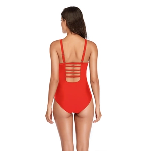 Detail of red one-piece swimsuit with open back design and adjustable metal buckles