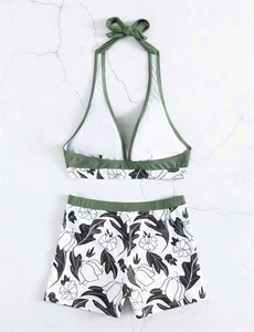 Detailed flat lay of olive green halter bikini set with high-waisted floral print bottoms