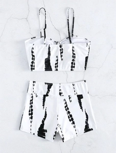 Flat lay of women's two-piece swimsuit with black tie-dye stripes and high waist shorts