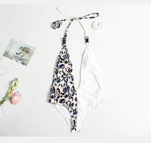 Flat lay of a deep V-neck monokini with leopard print and white color-block design