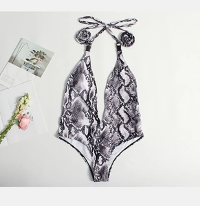 Detail of snake skin print one-piece swimsuit with deep V-neck and halter neck straps