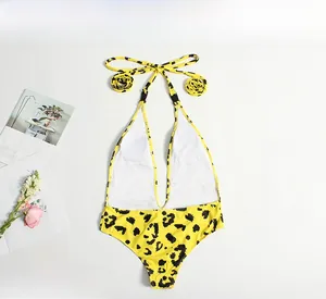 Detailed flat lay of leopard print one-piece swimsuit with halter neck and deep V-neckline