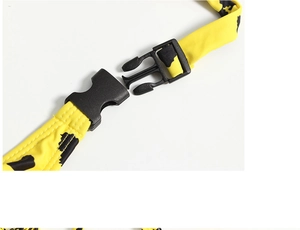 Detail view of bright yellow cow-print strap with black plastic buckle and stitching