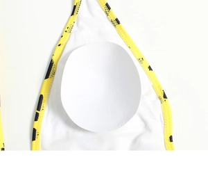 Detail view of yellow leopard print swimsuit featuring removable soft cup and XS size mark
