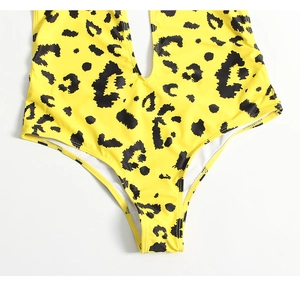 Detailed macro view of yellow leopard print one-piece swimsuit fabric and stitching