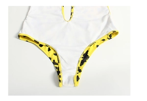 Detailed view of yellow leopard print swimsuit featuring durable stitching and white lining