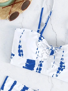 Detail of blue tie-dye bikini top with thin straps and adjustable drawstring ties